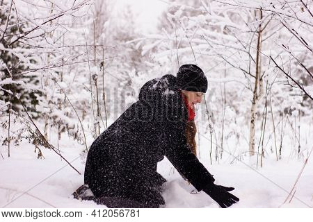 Beautiful Sexy Girl Tosing Snow. Around The Trees In The Snow
