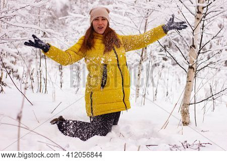 Beautiful Sexy Girl Tosing Snow. Around The Trees In The Snow