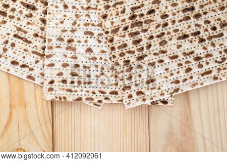 Jewish Matzah On Wooden Rustic Background. Jewish Traditional Passover Bread. Pesach Celebration Sym