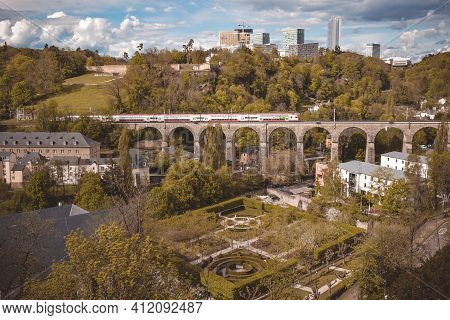 View Of The Krisberg Viaduct Railway Bridge With A Passing Train. Luxembourg City. Luxembourg. April
