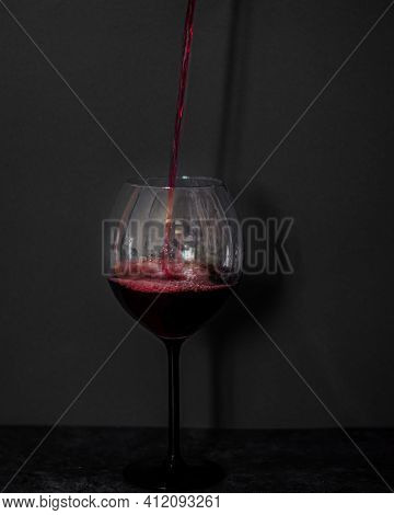 A Glass Of Red Wine On A Colostrum Background
