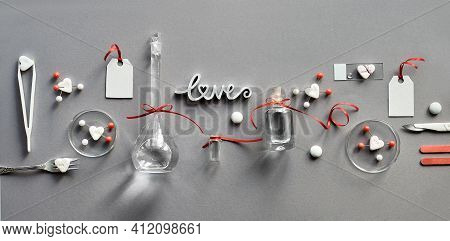 Chemistry Of Love. Creative Flat Lay On Grey Paper. Top View With Chemical Glassware, Petri Dishes, 