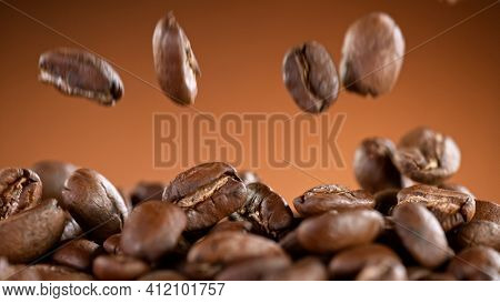 Falling Roasted Coffee Beans, Macro Shot, close-up.