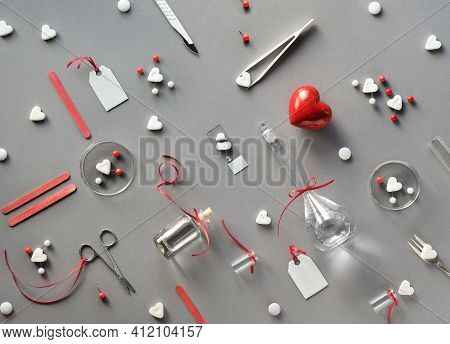 Chemistry Of Love. Creative Flat Lay On Grey Paper. Top View With Chemical Glassware, Petri Dishes, 