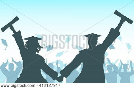Graduates Girl And Guy Hold Hands With Diploma On Background Of Cheerful Crowd Of Graduates Throwing