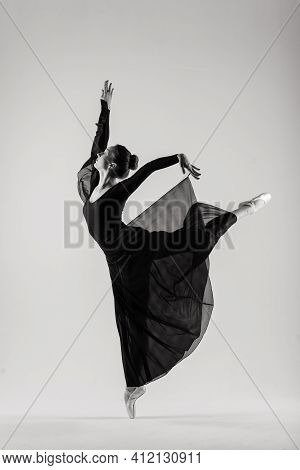 Portarit Of Sensual Professional Caucasian Callet Dancer In Body Suit And Pointes Shoes On White.