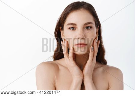 Skin Care. Young Beauty Woman With Natural Make Up, Touching Hydrated And Nourished Facial Skin, Hol
