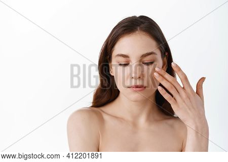 Skin Care. Young Woman Gently Touching Soft And Hydrated Skin On Face, Applying Moisturizing Cream O