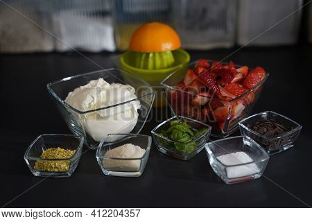 Ingredients For A Dessert With Double Cream Cream Cheese, Strawberries, Chopped Pistachios, Sugar, O