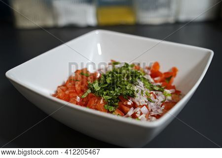 Preparation For Bruscetta Make The Ingredients For The Topping In A White Bowl.