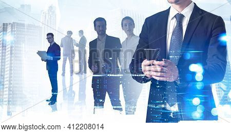 Businessman In Suit Checking News In The Internet Using Smartphone. Working At International Consult