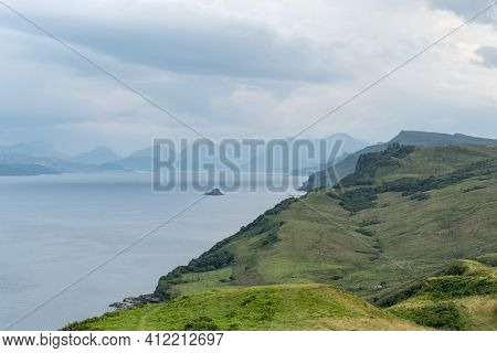 Scottish Landscape With Hills And Shoreline Near Staffin City  At Isle Of Skye, Scotland With Green 