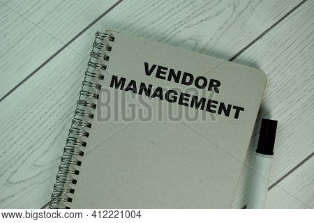 The Book About Vendor Management Isolated On Wooden Table.