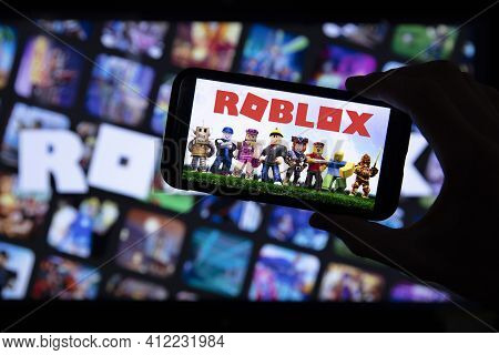 London, Uk - March 2021: Person Holding A Smartphone With Roblox Game Logo