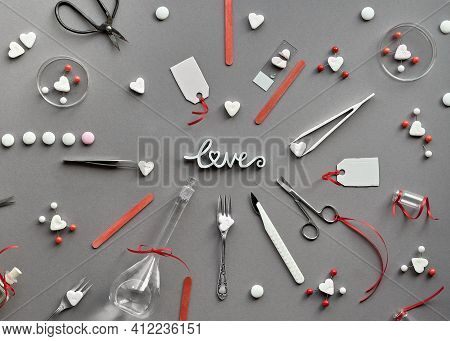 Chemistry Of Love. Creative Flat Lay On Grey Paper. Top View With Chemical Glassware, Petri Dishes, 
