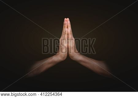 Hands Clasped. Man Hands In Praying Position On Black Background. Faith In Religion And Belief In Go