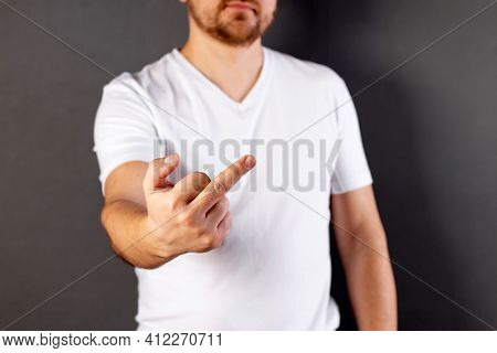 Man Shows Fuck Off Gesture To Camera. Middle Finger, Offensive Gesture. Fuck You Concept.