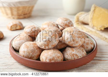 Plate With Tasty Homemade Gingerbread Cookies On White Wooden Table
