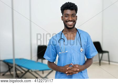 Laughing African Male Nurse At Vaccination Station Is Ready For Vacinating Patients Against Coronavi