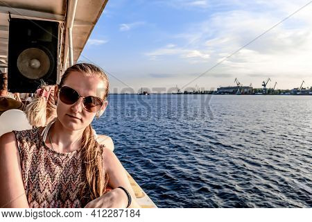 Portrait Of A Young Adult Girl Traveling On Board A Tourist Ship On The Dnieper River Against The Ba