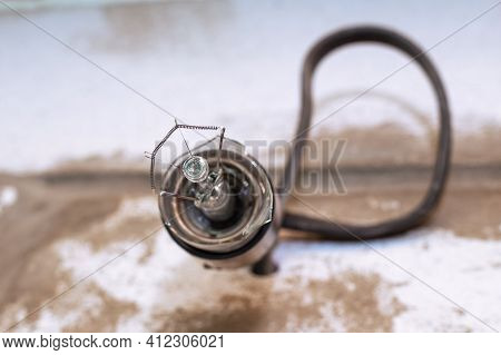 An Exploded Light Bulb In An Electric Socket Close-up. Electricity Concept, Lighting Problems.