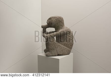 Madrid, Spain - Jul 11th, 2020: Shaman Smoking Tobacco Leaves In A Healing Ceremony. Carved Stone. P