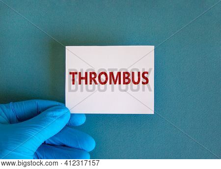 Medical And Thrombus Symbol. Doctor Hand. White Card With The Word 'thrombus'. Beautiful Blue Backgr
