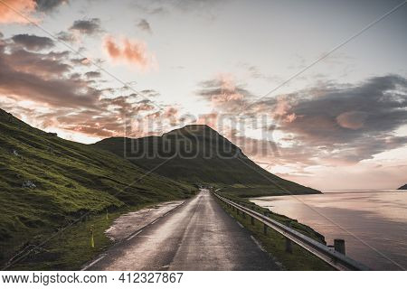 Faroe Islands Kalsoy In Sunset Light Durig Twilight With Pink Sky And Cliffs.