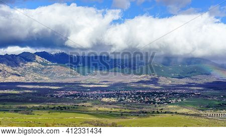 Aerial View Green Mountain Landscape With Dark Clouds And Villages With Houses On The Mountainside. 
