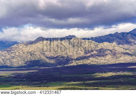 Aerial View Green Mountain Landscape With Dark Clouds And Villages With Houses On The Mountainside. 