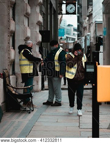 London Uk February 2021 Three Workers On The Streets Of London Wearing Yellow High Visibility Jacket