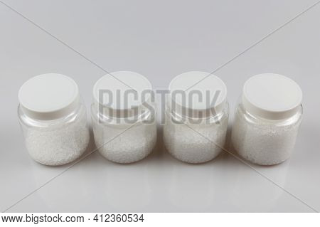 Transparent Bottle Inside With Plastic Beads. White Polymer. White Plastic Beads.