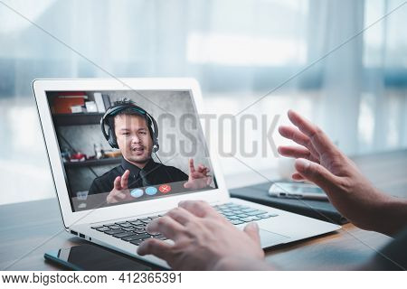 Asian Business Man Making Facetime Video Calling Using Online Meeting Via Laptop Computer At Home Of