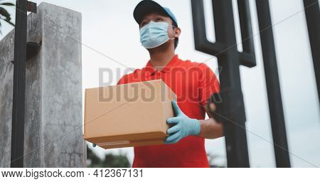 New Normal Life Style. Home Delivery Shopping Box Man Wearing Gloves And Protective Mask Delivering 