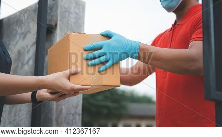 New Normal Life Style. Home Delivery Shopping Box Man Wearing Gloves And Protective Mask Delivering 