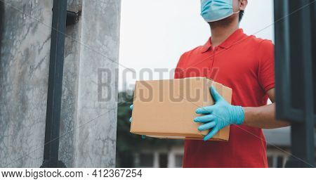 New Normal Life Style. Home Delivery Shopping Box Man Wearing Gloves And Protective Mask Delivering 
