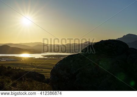 Sunset In The Mountains With Water Lake In The Valley And Sun Rays In The Blue Sky. Navacerrada Madr