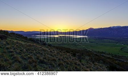 Sunset In The Mountains With Water Lake In The Valley And Sun Rays In The Blue Sky. Navacerrada Madr