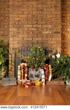 Vintage House Decorated With Small Christmas Tree Placed In Front Of A Fireplace. The Gifts Are Arra
