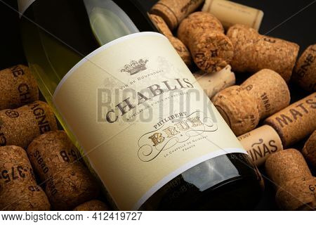 St Petersburg, Russia - 14 March 2021, Chablis Bottle Among Wine Corks Label Close-up