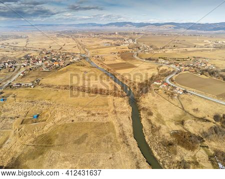 Curving Olt River Near Asphalt Road Aerial Drone View In Transylvania, Romania.