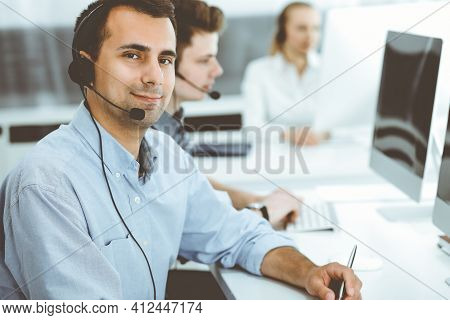 Call Center. Group Of Casual Dressed Operators At Work. Adult Businessman In Headset At Customer Ser