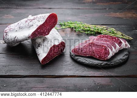 Longaniza, Dry Cured Traditional Sausage Cut To Slices On Dark Wooden Background.