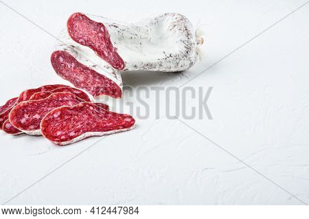 Sliced Cuts Of Longaniza, Dry Cured Spanish  Sausage On White Textured Background With Space For Tex