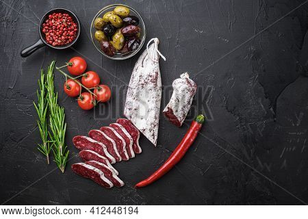 Spanish Longaniza Salami Sausage Slices With Herbs On Balck Background, Flat Lay With Copy Space.