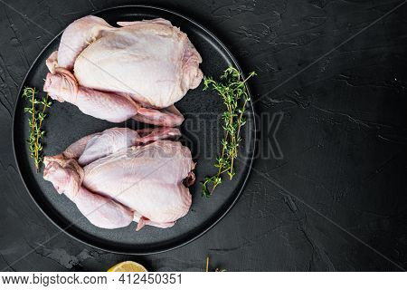 Raw Coquelet Chickens Meat With Herbs Spices, On Black Background, Top View With Copy Space For Text
