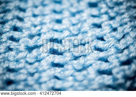 An Extreme Close-up Shot With Selective Focus Of A Piece Of Deep Blue Knitted Fabric.