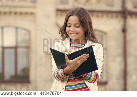 Access To Much More Than Just Book. Knowledge Concept. Little Girl Hold Book. Girl With Book School 