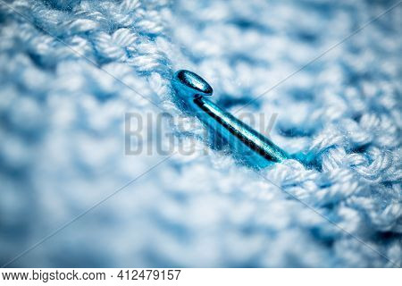 An Extreme Close-up Shot With Selective Focus Of A Piece Of Deep Blue Knitted Fabric With Blue Croch