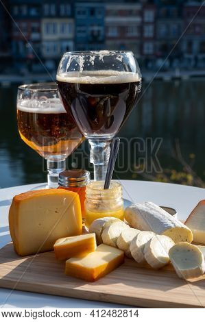 Glass Of Belgian Abbey Beer And Tasting Of Cheeses Made With Trappist Beer And Fine Herbs With View